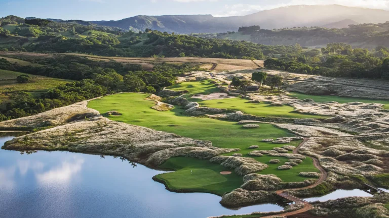 La Réserve Golf Links course among hills and a lake in Mauritius